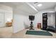 Basement gym with fitness equipment, carpeted floor, and adjacent room with bedroom access at 13132 Pennsylvania Cir, Thornton, CO 80241