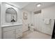 Bathroom featuring white vanity, framed mirror, toilet, and shower with curtain at 13132 Pennsylvania Cir, Thornton, CO 80241