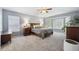 Spacious bedroom features carpet, blinds, plants, and neutral paint at 13132 Pennsylvania Cir, Thornton, CO 80241