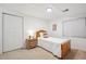 Cozy bedroom with a bed, dresser, carpet, and a window providing natural light at 13132 Pennsylvania Cir, Thornton, CO 80241