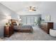 Spacious bedroom featuring a cozy bay window, ceiling fan, and neutral gray carpet at 13132 Pennsylvania Cir, Thornton, CO 80241