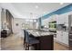 Modern kitchen features a center island with seating, white cabinets, and stainless steel appliances at 13132 Pennsylvania Cir, Thornton, CO 80241