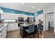 Stylish kitchen featuring white cabinets, granite countertops, and a functional center island with seating at 13132 Pennsylvania Cir, Thornton, CO 80241