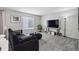 A cozy living room features carpeted floors, stylish furnishings, and natural light at 13132 Pennsylvania Cir, Thornton, CO 80241
