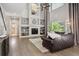 Bright living room with a fireplace, large windows, and hardwood floors at 13132 Pennsylvania Cir, Thornton, CO 80241
