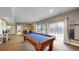 Basement featuring a pool table, seating area, and sliding door to a patio at 4300 W 105Th Pl, Westminster, CO 80031