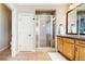 Bright bathroom featuring a glass-enclosed shower, vanity with sink, and neutral tile flooring at 4300 W 105Th Pl, Westminster, CO 80031