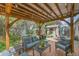 This backyard features a pergola-covered deck, comfortable seating, a grill, and a charming storage shed at 3451 Highland Pl, Westminster, CO 80031