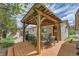 Inviting backyard patio boasts a wooden pergola, ample seating, grill, and mature landscaping at 3451 Highland Pl, Westminster, CO 80031