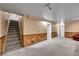 Finished basement boasts plush carpeting, wood paneled walls, and access to upper floors at 3451 Highland Pl, Westminster, CO 80031