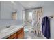 This bathroom features a tiled shower and tub, a tiled floor, and decorative shower curtains at 3451 Highland Pl, Westminster, CO 80031