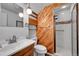 This renovated bathroom features wood paneling, modern fixtures, and a walk-in shower at 3451 Highland Pl, Westminster, CO 80031
