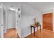 Bright entryway boasts hardwood floors, a decorative table, and a stained wood front door at 3451 Highland Pl, Westminster, CO 80031