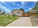 Side view of a home with a fenced-in yard and a long driveway to detached garage at 3451 Highland Pl, Westminster, CO 80031