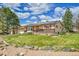 Landscaped front yard of a charming single Gathering home with solar panels on the roof at 3451 Highland Pl, Westminster, CO 80031