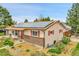 Charming home featuring solar panels, a well-manicured lawn, brick accents and eye-catching red shutters at 3451 Highland Pl, Westminster, CO 80031