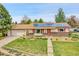 Inviting ranch home features solar panels, a lush lawn, and delightful garden beds, perfect curb appeal at 3451 Highland Pl, Westminster, CO 80031