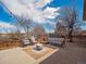 Backyard featuring an outdoor seating area, a fire pit, a stone patio and mature trees at 4179 E Peakview Cir, Centennial, CO 80121