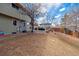 Expansive backyard featuring a stone patio with outdoor seating and a wood fence at 4179 E Peakview Cir, Centennial, CO 80121