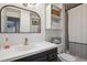 Bright bathroom featuring a modern sink, stylish mirror and shelving to maximize your space for storage and organization at 4179 E Peakview Cir, Centennial, CO 80121