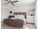 Comfortable bedroom with a ceiling fan, natural light from the window and a dark-stained wooden bed frame at 4179 E Peakview Cir, Centennial, CO 80121