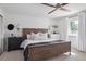 Comfortable bedroom with a ceiling fan, natural light from the window and a dark-stained wooden bed frame at 4179 E Peakview Cir, Centennial, CO 80121