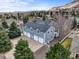 Spacious four-car garage with blue siding, white trim, and a large driveway, perfect for car enthusiasts at 5753 Secrest Ct, Golden, CO 80403