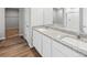 Elegant bathroom with dual sinks, granite countertops, and a combined shower and tub at 2235 Alyssa St, Fort Lupton, CO 80621