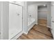Modern bathroom with white tile shower, separate bathtub, and walk-in closet at 2235 Alyssa St, Fort Lupton, CO 80621
