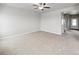 Spacious bedroom featuring neutral carpeting, ceiling fan, and ample natural light from the window at 2235 Alyssa St, Fort Lupton, CO 80621