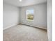 Cozy bedroom with plush carpeting and a bright window, offering a comfortable retreat at 2235 Alyssa St, Fort Lupton, CO 80621