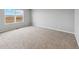 Inviting bedroom with plush carpeting, neutral walls, and a large window offering scenic views at 2235 Alyssa St, Fort Lupton, CO 80621