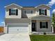 Charming two-story home featuring a spacious two-car garage, well-manicured lawn, and inviting front entrance at 2235 Alyssa St, Fort Lupton, CO 80621