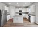 Bright kitchen featuring stainless steel appliances, granite countertops, and a center island with breakfast bar at 2235 Alyssa St, Fort Lupton, CO 80621