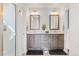 Bathroom featuring double sink vanity with wood cabinets and framed mirrors at 601 Tenderfoot Dr, Berthoud, CO 80513