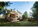 Beautiful backyard featuring a multi-level deck, covered patio, hot tub and mature trees providing privacy at 924 Glen Oaks Ave, Castle Pines, CO 80108
