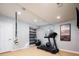 Basement workout space featuring a treadmill, exercise ball, and hanging resistance trainer at 924 Glen Oaks Ave, Castle Pines, CO 80108