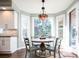 Cozy dining area with large windows, a chandelier, and hardwood floors at 924 Glen Oaks Ave, Castle Pines, CO 80108