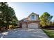 Charming two-story brick home featuring an attached two-car garage and a well-manicured front yard at 924 Glen Oaks Ave, Castle Pines, CO 80108
