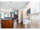 Open kitchen design with a center island, granite countertops and hardwood floors at 924 Glen Oaks Ave, Castle Pines, CO 80108