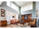 Bright living room with large windows, hardwood floors, and a built-in entertainment center at 924 Glen Oaks Ave, Castle Pines, CO 80108