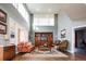 Living room with large windows, fireplace, built-in bookshelves and hardwood floors at 924 Glen Oaks Ave, Castle Pines, CO 80108