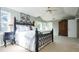 Spacious bedroom featuring a decorative metal bed frame, large windows, and an elegant wooden wardrobe at 924 Glen Oaks Ave, Castle Pines, CO 80108