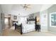 Spacious main bedroom suite featuring a fireplace, large windows, and a ceiling fan at 924 Glen Oaks Ave, Castle Pines, CO 80108