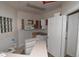 Compact kitchen with open cabinets and a view to the front yard at 1631 W Canal Cir # 832, Littleton, CO 80120