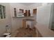 Compact kitchen with open cabinets ready for renovation and customization at 1631 W Canal Cir # 832, Littleton, CO 80120