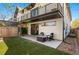A backyard featuring a patio with a fire pit, chairs, and artificial grass at 5240 N Raleigh St, Denver, CO 80212
