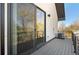 Balcony with railing and sliding door, looking over lush greenery and other homes at 5240 N Raleigh St, Denver, CO 80212