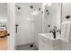 Modern bathroom featuring a glass enclosed shower with sleek fixtures and a floating vanity with contemporary hardware at 5240 N Raleigh St, Denver, CO 80212