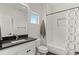 Bathroom featuring modern fixtures, tiled floors, a shower and a window providing natural light at 5240 N Raleigh St, Denver, CO 80212